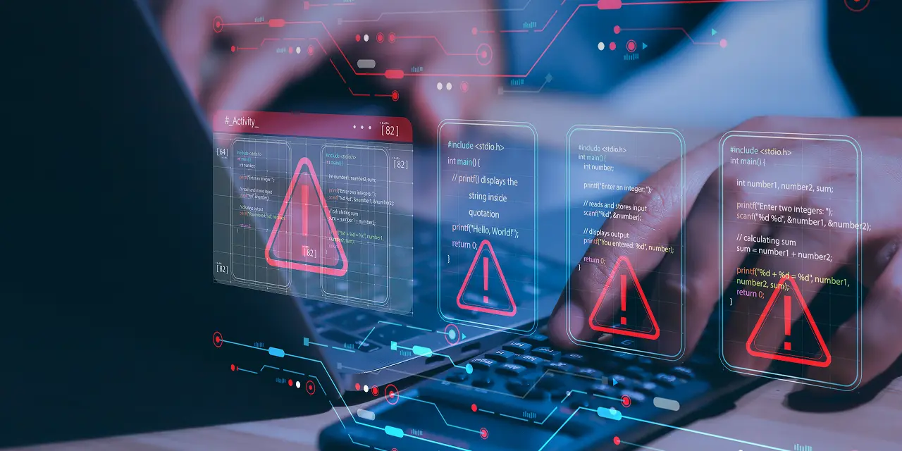 Fotografía de una persona utilizando un ordenador que está editada con hologramas de alerta